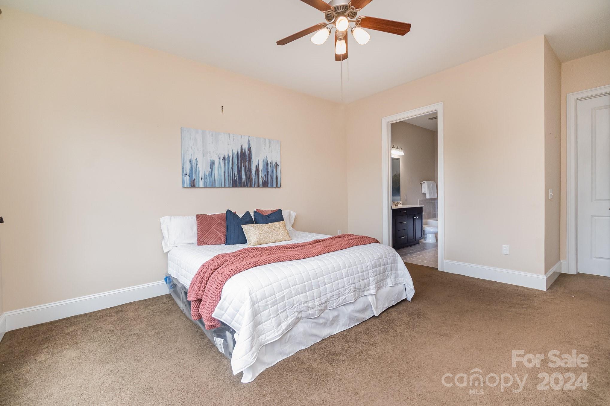 5425 Closeburn Road, Unit 213 Charlotte, NC 28210 - Photo 19 of 32 a bed room with a bed and a ceiling fan