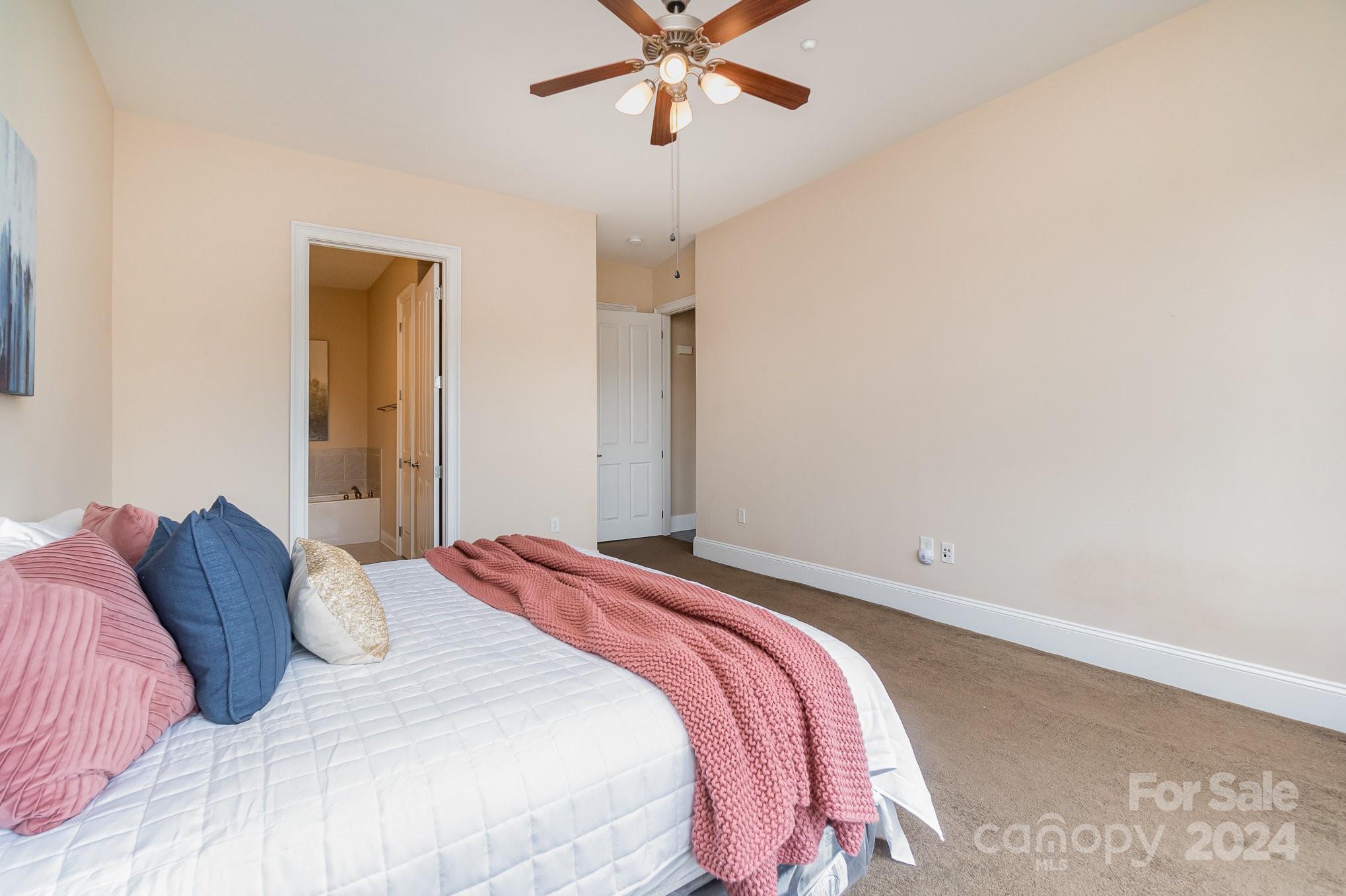 5425 Closeburn Road, Unit 213 Charlotte, NC 28210 - Photo 20 of 32 a bedroom with a bed and a ceiling fan