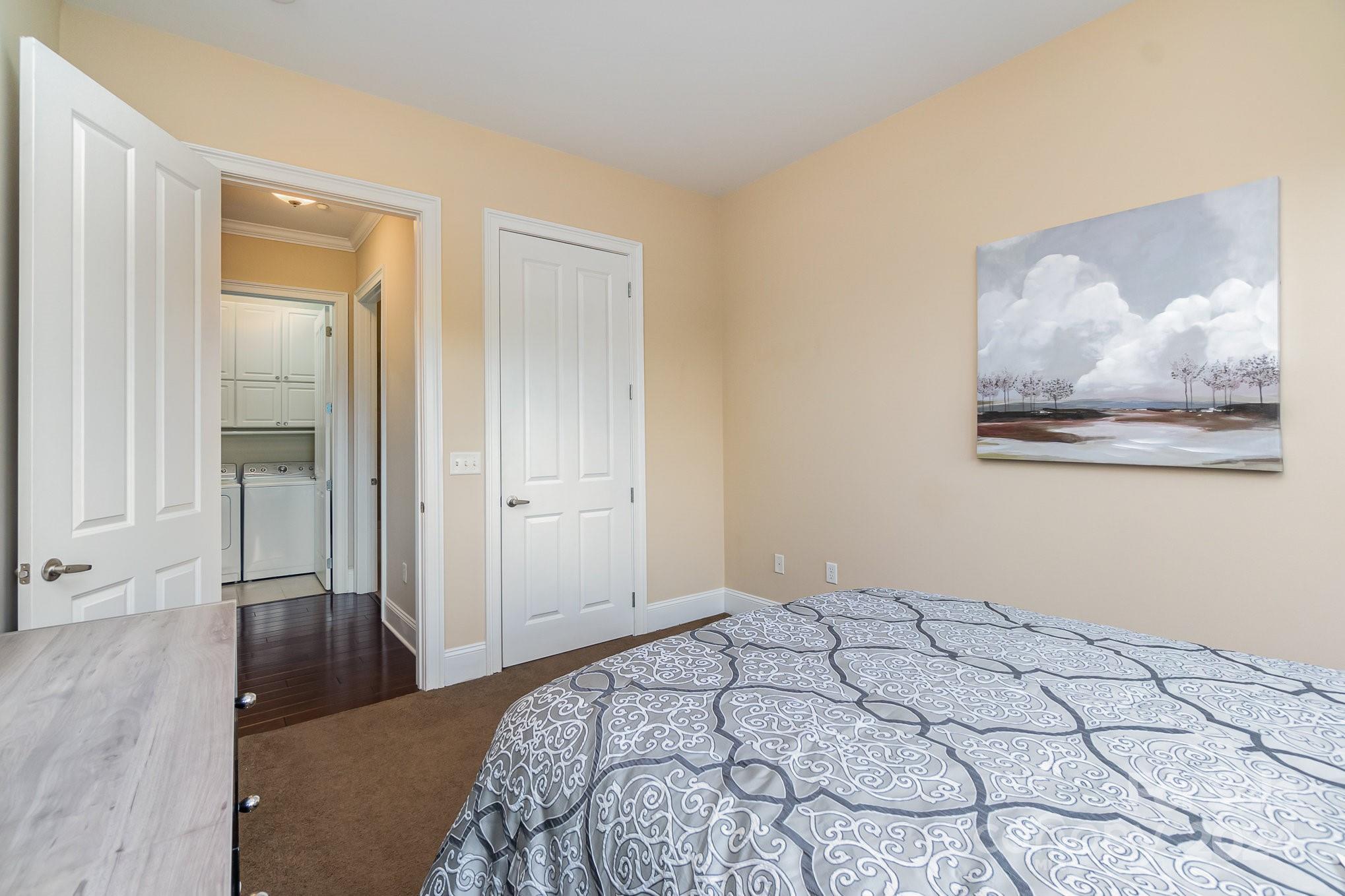 5425 Closeburn Road, Unit 213 Charlotte, NC 28210 - Photo 25 of 32 a bedroom with a bed and a painting on the wall