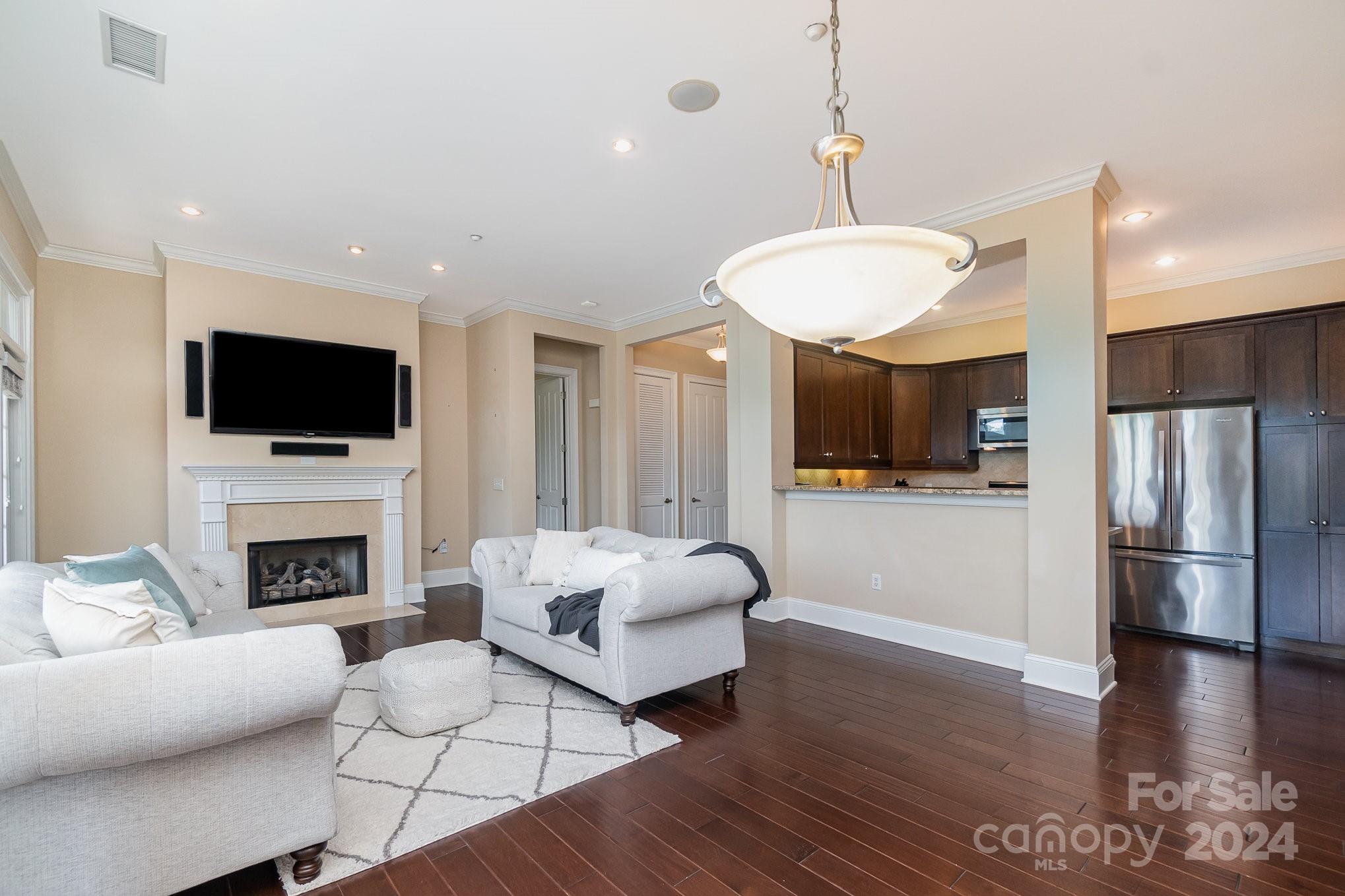 5425 Closeburn Road, Unit 213 Charlotte, NC 28210 - Photo 8 of 32 a living room with furniture fireplace and flat screen tv