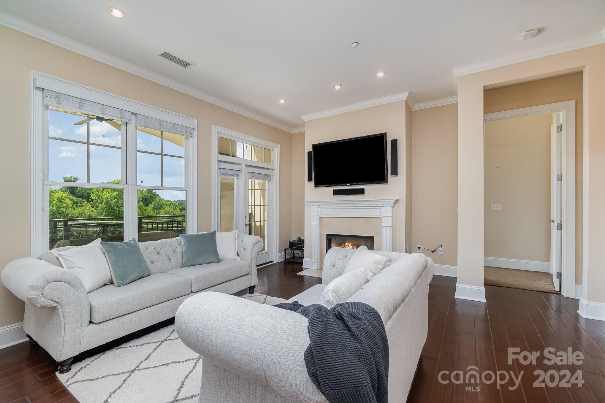 5425 Closeburn Road, Unit 213 Charlotte, NC 28210 - Photo 9 of 32 a living room with fireplace furniture and a flat screen tv