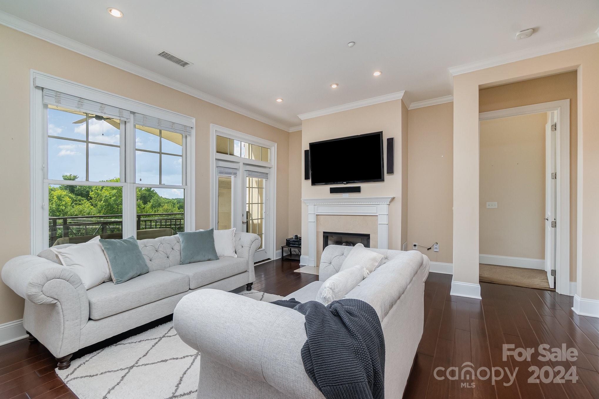 5425 Closeburn Road, Unit 213 Charlotte, NC 28210 - Photo 10 of 32 a living room with fireplace furniture and a flat screen tv