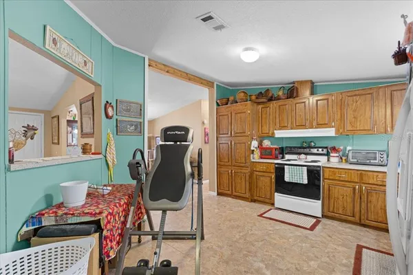 a kitchen with stainless steel appliances granite countertop a refrigerator and a stove top oven