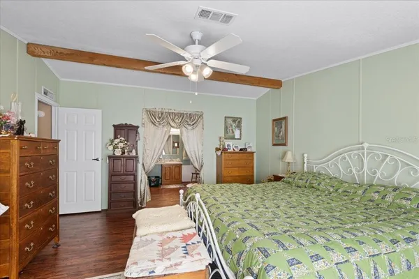 a bedroom with a large bed and a chandelier