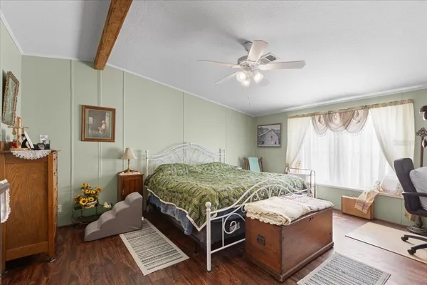 a bedroom with a bed couch and a window