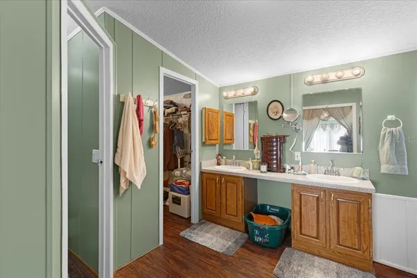 a room with stainless steel appliances kitchen island granite countertop a refrigerator and a sink
