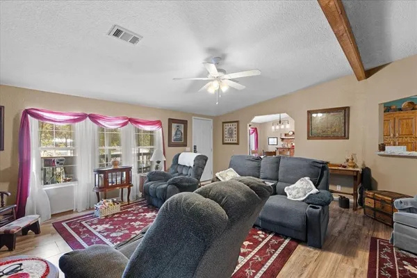 a living room with furniture and a chandelier