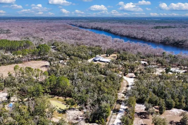 a view of a lake in middle of a forest