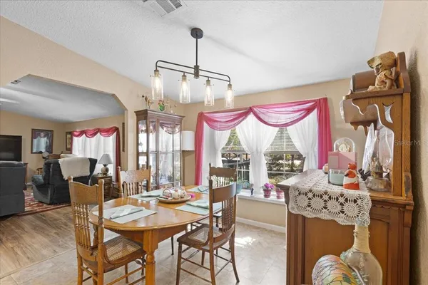 a view of a dining room with furniture window and outside view