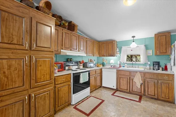 a kitchen with cabinets and window