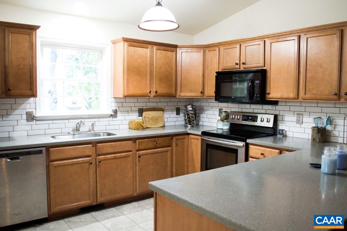 173 Top Ridge Road Stanardsville, VA 22973 - Photo 11 of 40 a kitchen with stainless steel appliances granite countertop a sink a stove and microwave