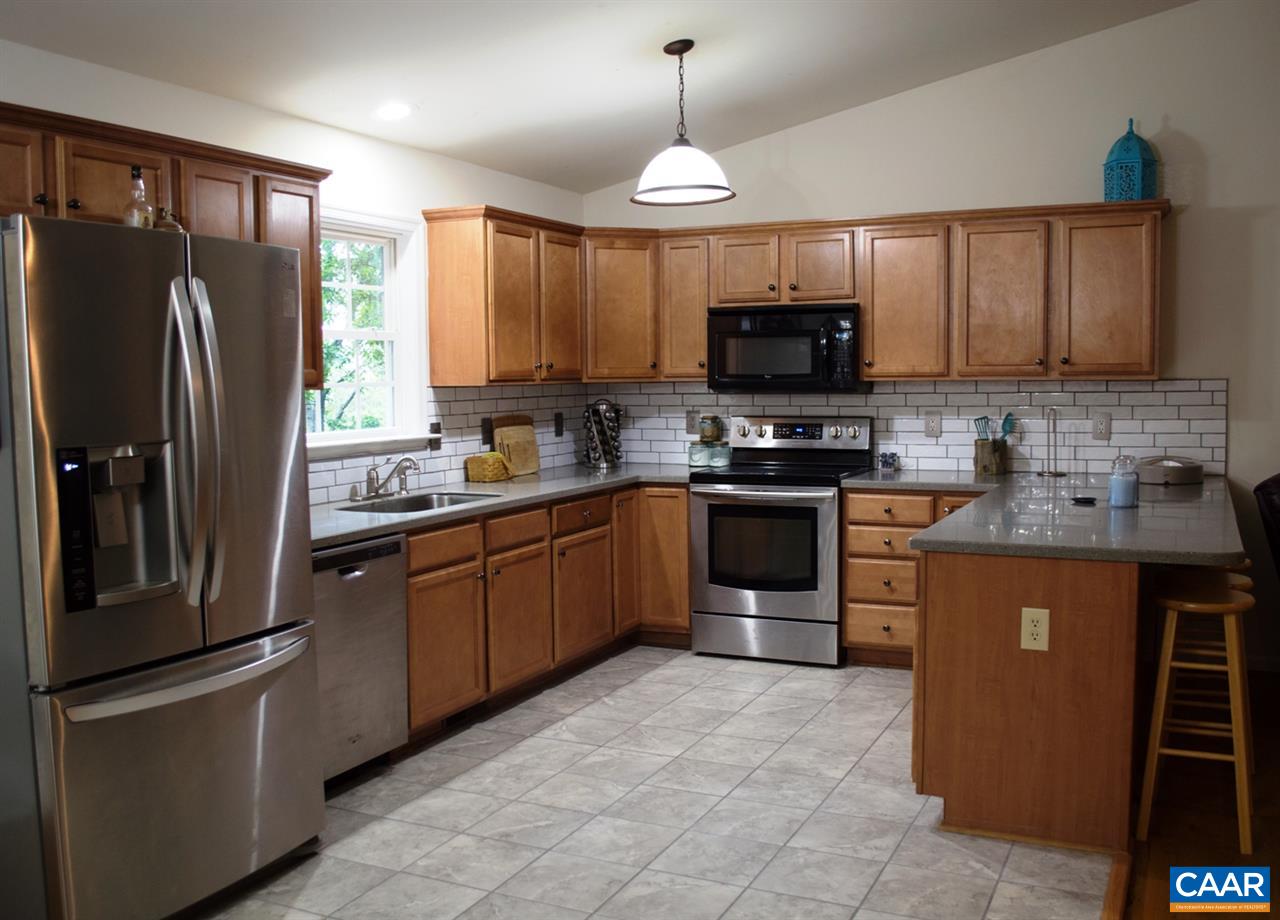 173 Top Ridge Road Stanardsville, VA 22973 - Photo 13 of 40 a kitchen with stainless steel appliances granite countertop a refrigerator a stove a sink and a microwave