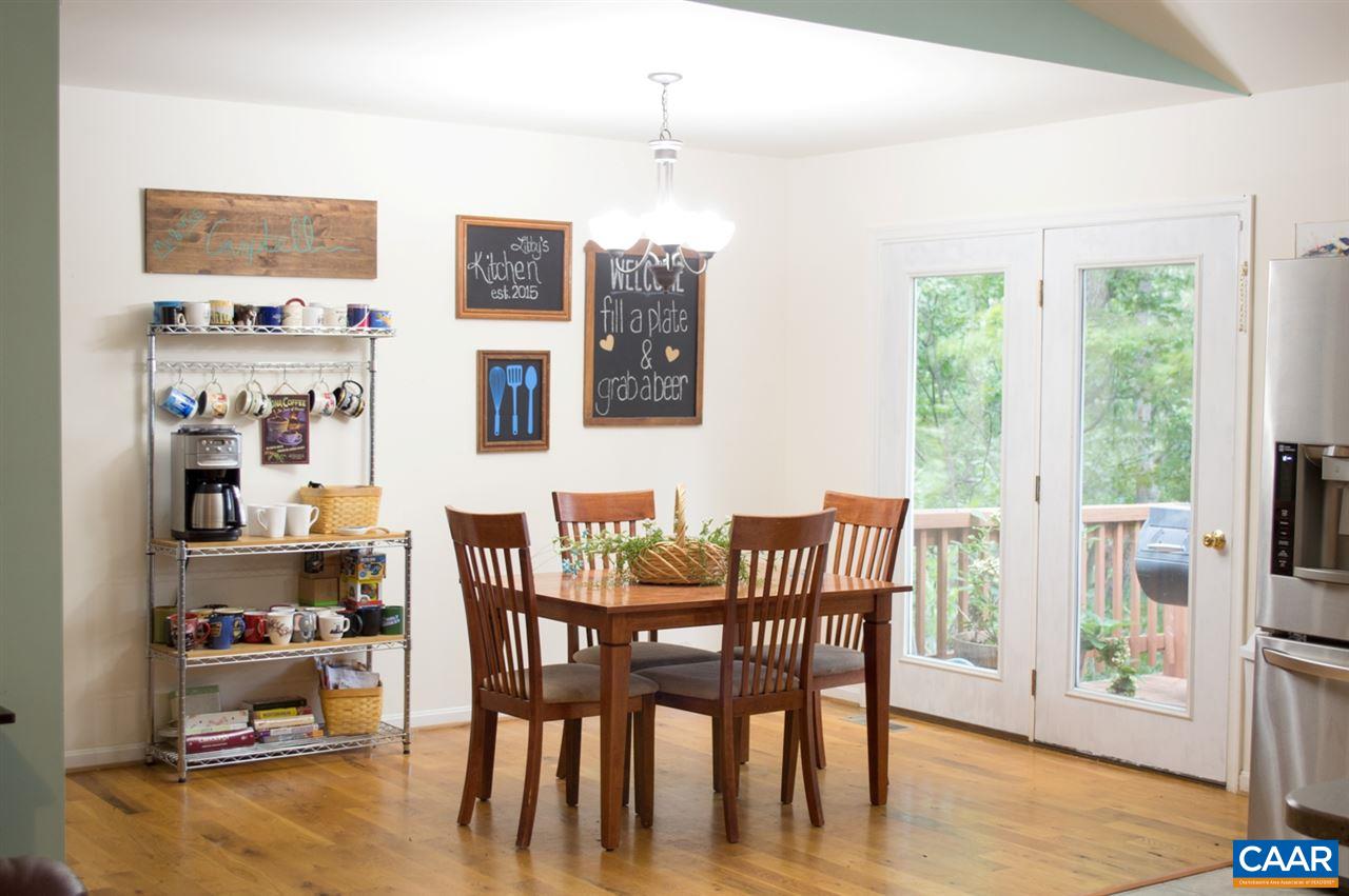 173 Top Ridge Road Stanardsville, VA 22973 - Photo 14 of 40 a dining room with wooden floor windows and a chandelier