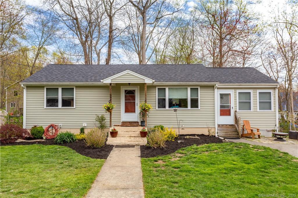 69 Spring Glen Road East Lyme, CT 06357 - Photo 1 of 1 a front view of a house with a garden and patio