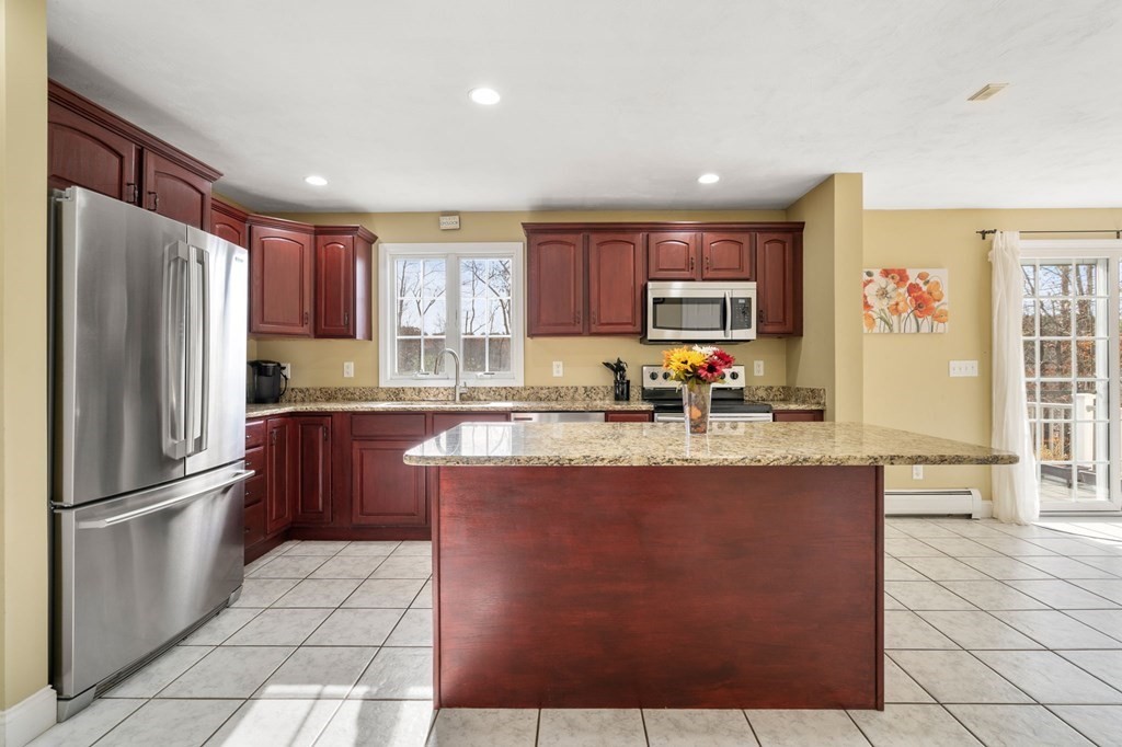 377 Main Street Rutland, MA 01543 - Photo 4 of 32 a kitchen with stainless steel appliances granite countertop a refrigerator a sink a stove a microwave and island