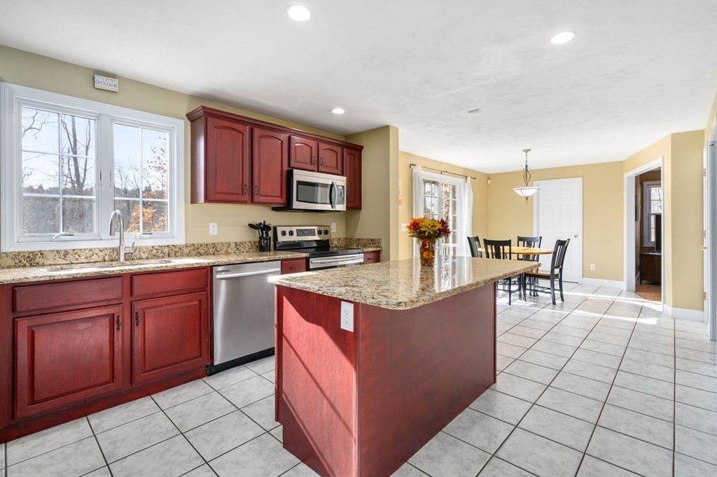 377 Main Street Rutland, MA 01543 - Photo 5 of 32 a kitchen with stainless steel appliances granite countertop a stove top oven a sink a counter top space and cabinets