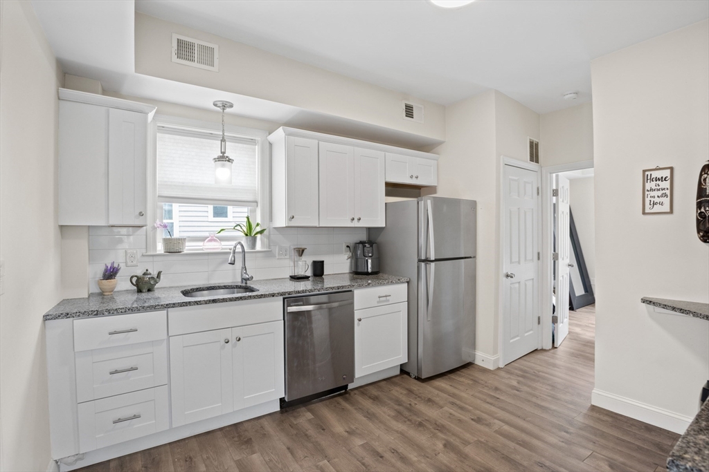 10 Elliott Place, Unit 3F Peabody, MA 01960 - Photo 1 of 15 a kitchen with stainless steel appliances a refrigerator sink and cabinets