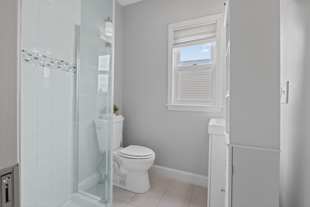 10 Elliott Place, Unit 3F Peabody, MA 01960 - Photo 12 of 15 a white toilet sitting next to a bathroom sink