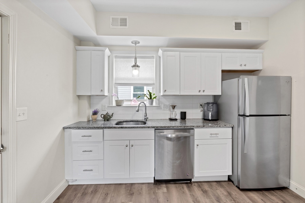 10 Elliott Place, Unit 3F Peabody, MA 01960 - Photo 3 of 15 a kitchen with white cabinets white stainless steel appliances and sink