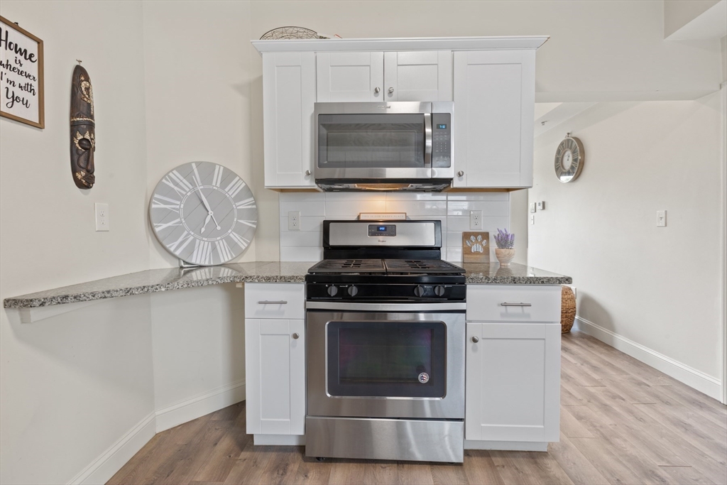 10 Elliott Place, Unit 3F Peabody, MA 01960 - Photo 4 of 15 a kitchen with a stove and a microwave