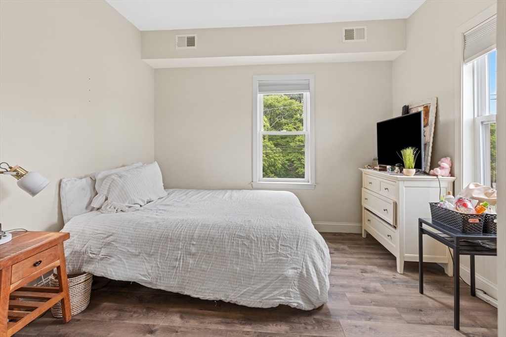 10 Elliott Place, Unit 3F Peabody, MA 01960 - Photo 9 of 15 a bedroom with a bed and a flat screen tv