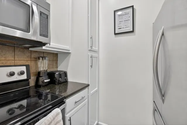a kitchen with a refrigerator and cabinets
