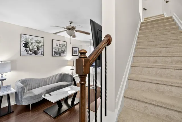 a living room with furniture and a stairs