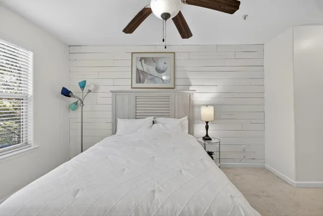 a bedroom with a bed and a painting on the wall