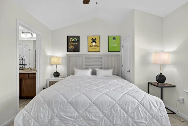 a bedroom with a bed and a lamp