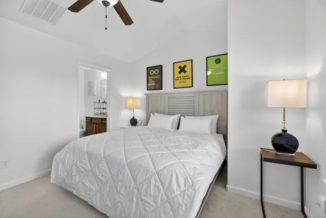 a bedroom with a bed and a lamp on table