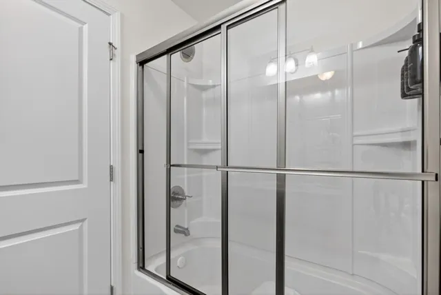 a bathroom with a glass shower door