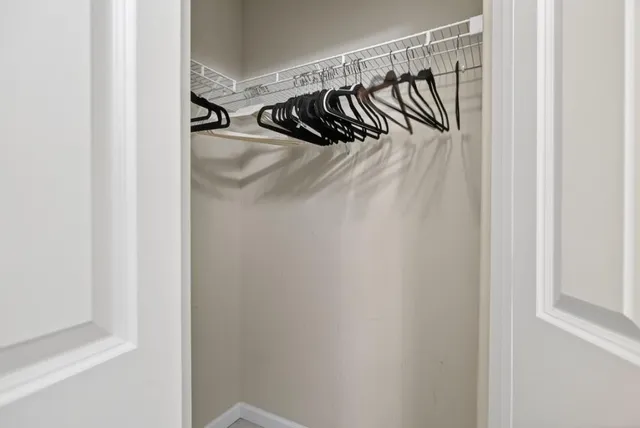 a view of walk in closet with clothes