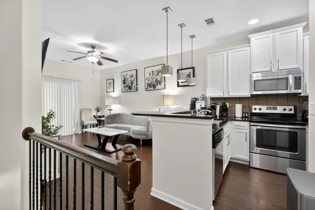 a kitchen with stainless steel appliances granite countertop a stove a sink and a refrigerator