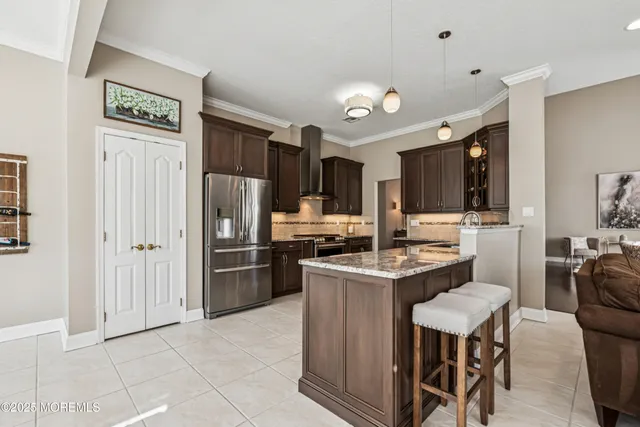 a kitchen with stainless steel appliances granite countertop a stove top oven a sink dishwasher a dining table and chairs