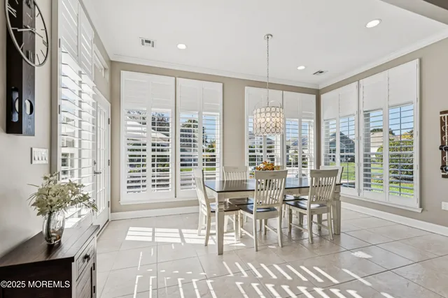 a spacious bedroom with a bed and a chandelier