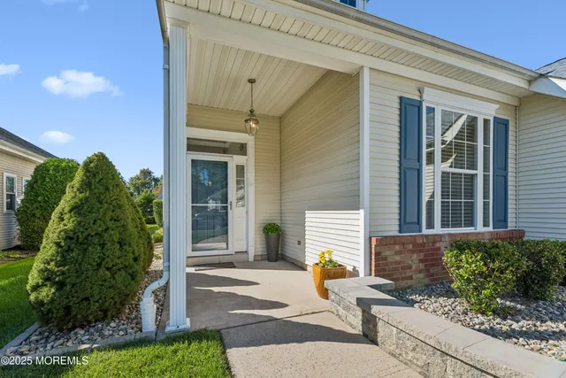 a view of a hallway with couch and dining area