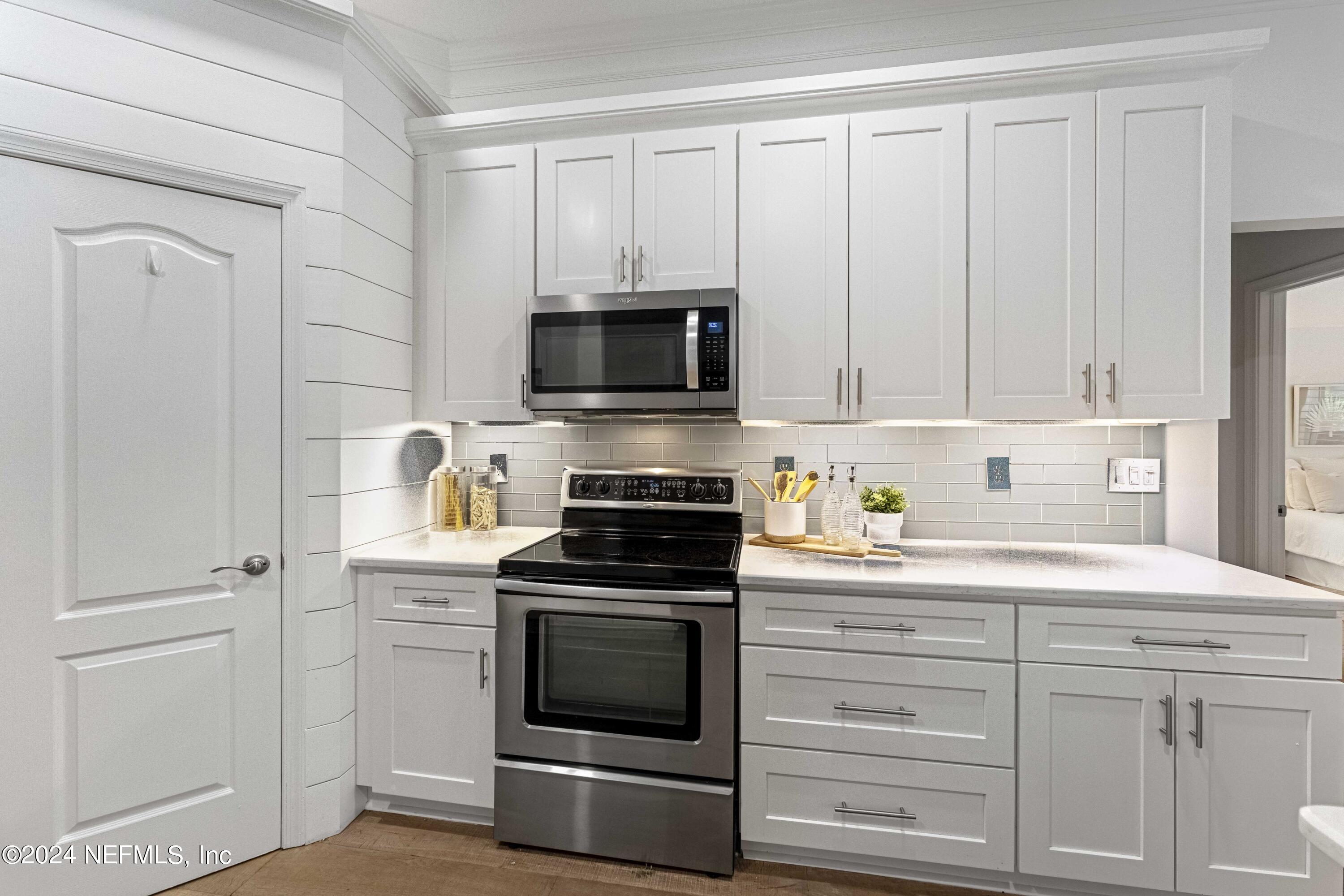 804 Mill Stream Road Ponte Vedra Beach, FL 32082 - Photo 22 of 67 a kitchen with white cabinets and stainless steel appliances