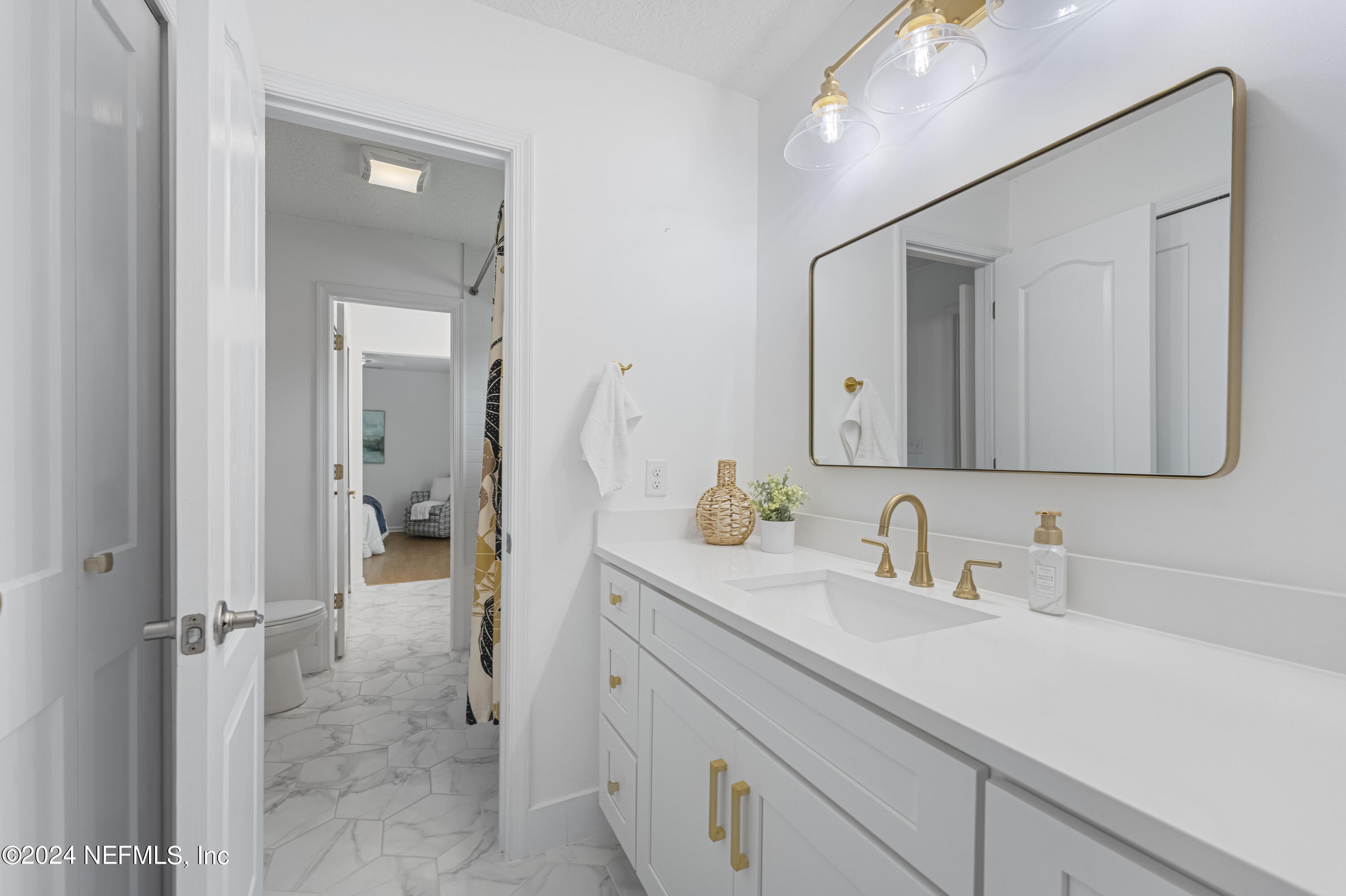 804 Mill Stream Road Ponte Vedra Beach, FL 32082 - Photo 40 of 67 a en suite bathroom with a sink a mirror and a shower