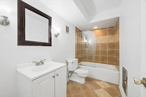 a bathroom with a bathtub sink mirror and toilet