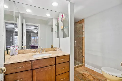 a bathroom with a sink mirror vanity and toilet