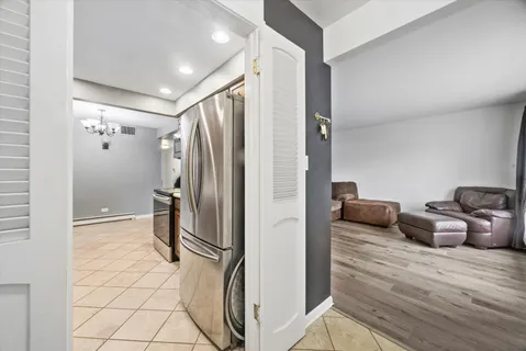a view of kitchen with furniture and refrigerator