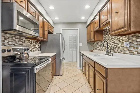 a kitchen that has a sink and a stove
