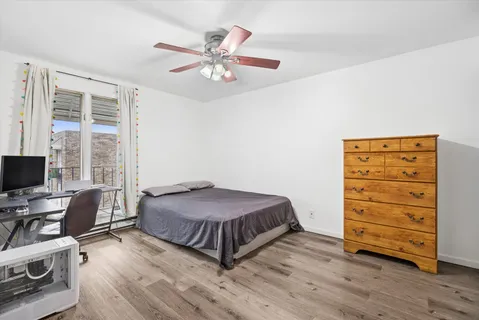 a bedroom with a bed and a desk