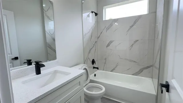 a bathroom with a sink a toilet and a bathtub