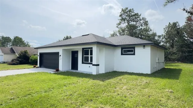 a view of a house with a yard and tree
