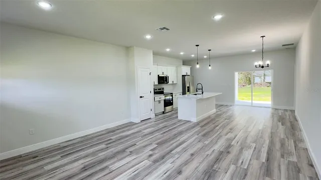 a view of a kitchen with wooden floor and a sink