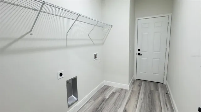 a view of a room with wooden floor and white walls