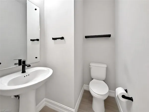 a bathroom with a shower sink and mirror