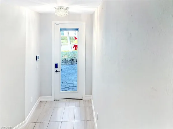 wooden floor in an empty room with a kitchen
