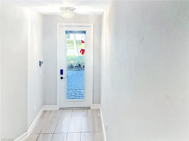 wooden floor in an empty room with a kitchen